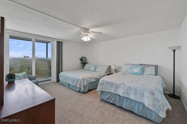 bedroom with a textured ceiling, access to outside, a ceiling fan, and carpet