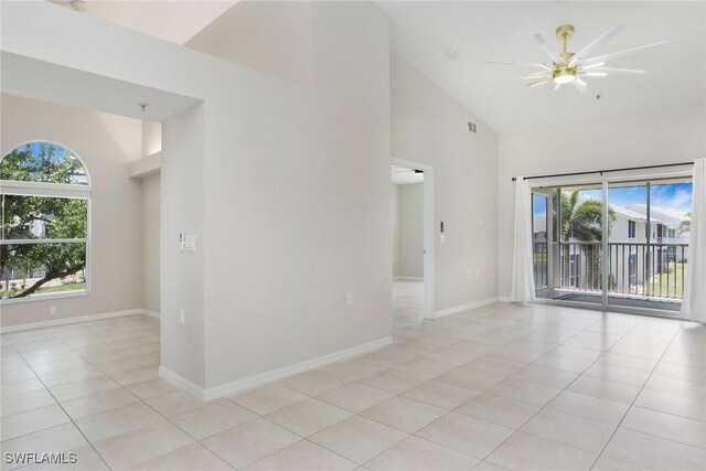4940 Cougar Ct S Unit 201, Naples, FL 34109 - spare room featuring light tile patterned flooring, high vaulted ceiling, visible vents, baseboards, and ceiling fan