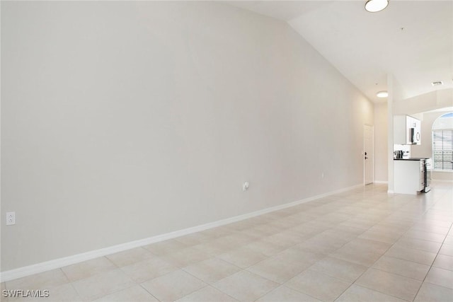 4940 Cougar Ct S Unit 201, Naples, FL 34109 - spare room featuring baseboards, lofted ceiling, and visible vents