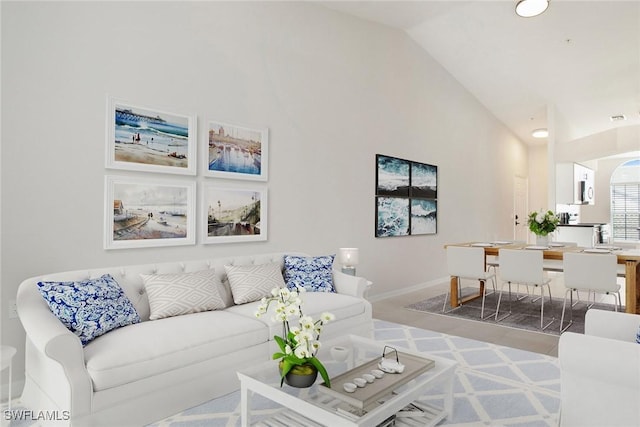 4940 Cougar Ct S Unit 201, Naples, FL 34109 - living area with baseboards and high vaulted ceiling