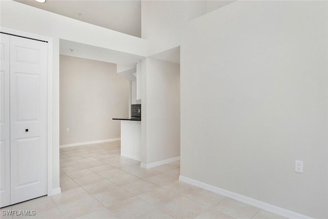 4940 Cougar Ct S Unit 201, Naples, FL 34109 - unfurnished room featuring baseboards and light tile patterned floors