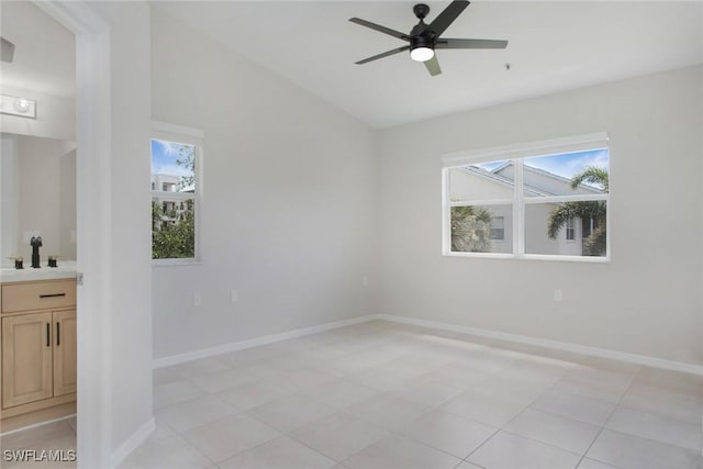4940 Cougar Ct S Unit 201, Naples, FL 34109 - spare room with baseboards, a ceiling fan, and a healthy amount of sunlight