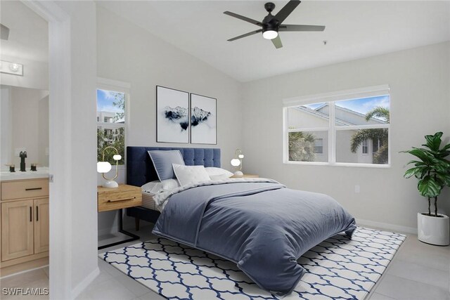 4940 Cougar Ct S Unit 201, Naples, FL 34109 - bedroom featuring baseboards, lofted ceiling, a sink, ensuite bath, and light tile patterned floors