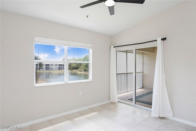 4940 Cougar Ct S Unit 201, Naples, FL 34109 - spare room featuring baseboards, lofted ceiling, and ceiling fan