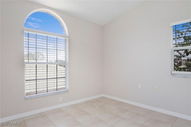 4940 Cougar Ct S Unit 201, Naples, FL 34109 - spare room with baseboards and light tile patterned floors