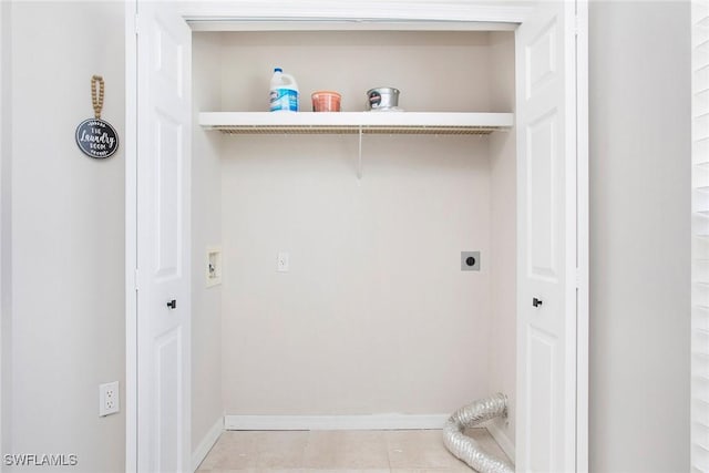 4940 Cougar Ct S Unit 201, Naples, FL 34109 - laundry area with light tile patterned flooring, baseboards, laundry area, and electric dryer hookup
