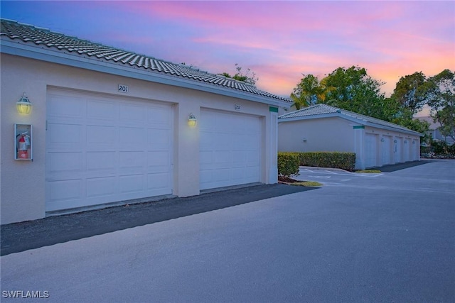 4940 Cougar Ct S Unit 201, Naples, FL 34109 - view of garage at dusk