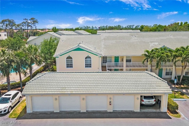 4940 Cougar Ct S Unit 201, Naples, FL 34109 - view of front of home with stucco siding and a tile roof
