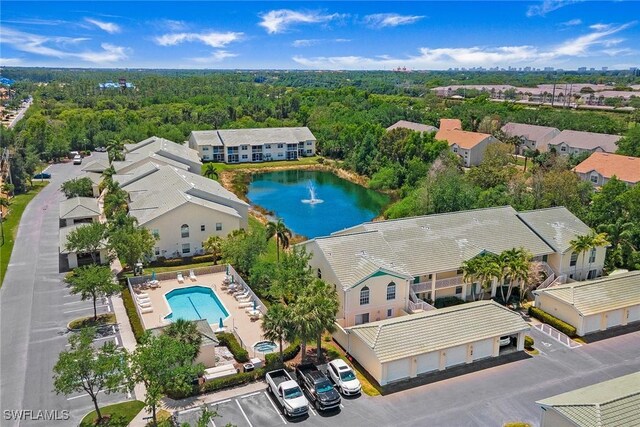 4940 Cougar Ct S Unit 201, Naples, FL 34109 - bird's eye view with a water view and a forest view