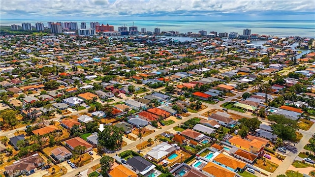 birds eye view of property with a city view and a water view
