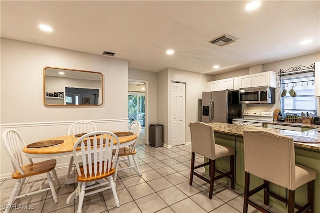 kitchen with stainless steel appliances, recessed lighting, and visible vents