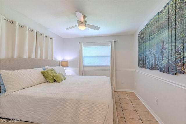 bedroom featuring light tile patterned flooring, ceiling fan, and baseboards