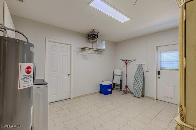 washroom featuring electric water heater, washer / clothes dryer, laundry area, and light tile patterned floors