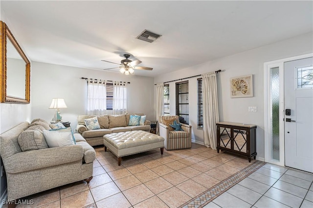 living room with light tile patterned floors, a ceiling fan, and visible vents