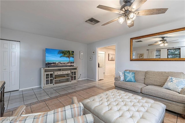 tiled living area with baseboards, a ceiling fan, and visible vents