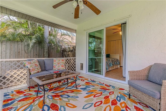 exterior space featuring an outdoor living space, ceiling fan, and fence
