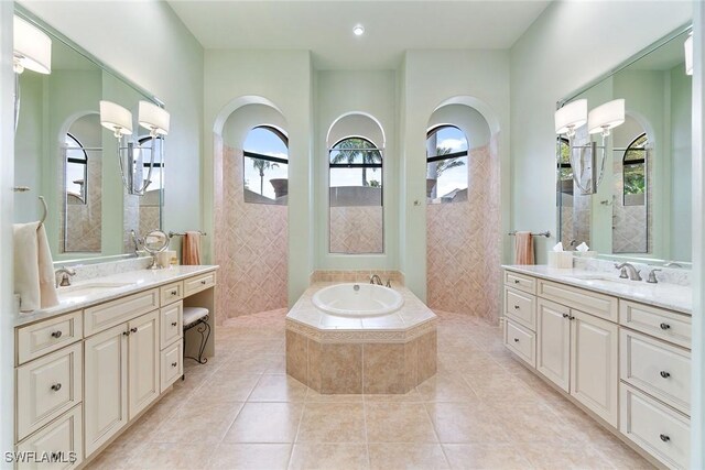 12581 Vittoria Way, Fort Myers, FL 33912 - full bathroom with tile walls, walk in shower, two vanities, tile patterned floors, and a bath