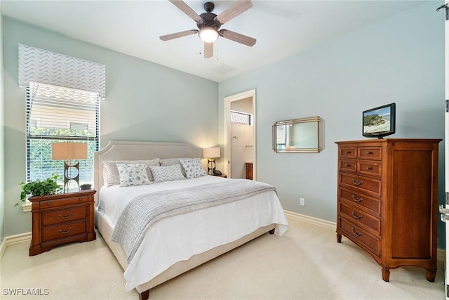 12581 Vittoria Way, Fort Myers, FL 33912 - bedroom featuring light carpet, baseboards, a ceiling fan, and connected bathroom