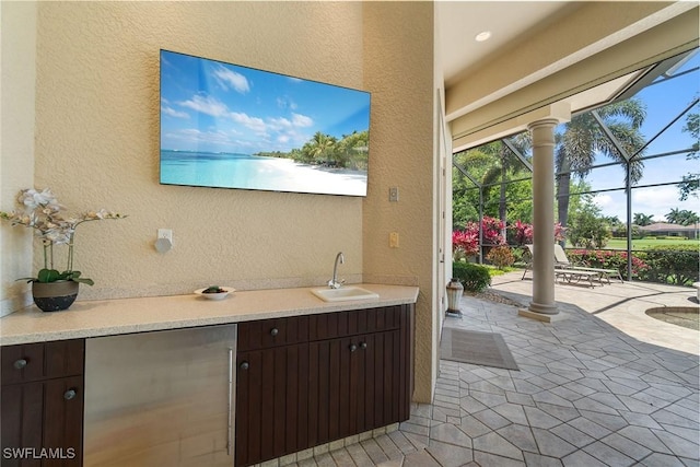 12581 Vittoria Way, Fort Myers, FL 33912 - view of patio featuring a sink and a lanai