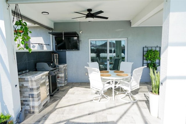 2533 SW 17th Pl, Cape Coral, FL 33914 - view of patio with a ceiling fan, exterior kitchen, a grill, and outdoor dining space