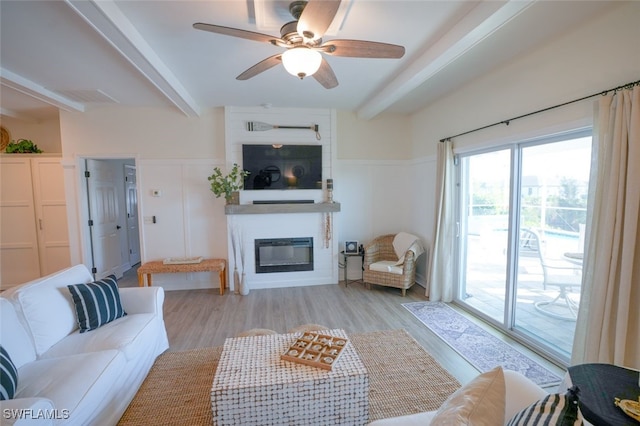 2533 SW 17th Pl, Cape Coral, FL 33914 - living room featuring light wood-type flooring, ceiling fan, beam ceiling, and a large fireplace