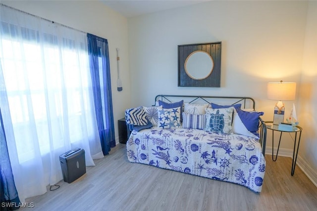 2533 SW 17th Pl, Cape Coral, FL 33914 - bedroom with baseboards and wood finished floors