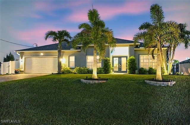 2533 SW 17th Pl, Cape Coral, FL 33914 - ranch-style house with concrete driveway, stucco siding, french doors, a front lawn, and a garage