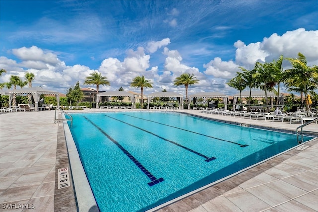 community pool with a pergola and a patio