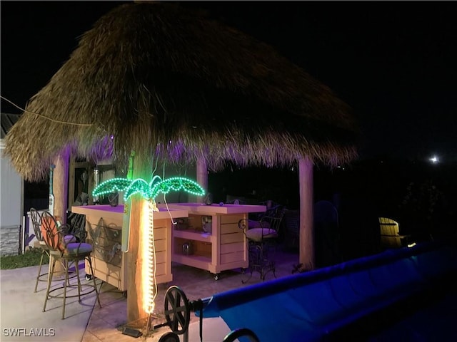 4238 Gardner Dr, Port Charlotte, FL 33952 - patio at night featuring outdoor dry bar