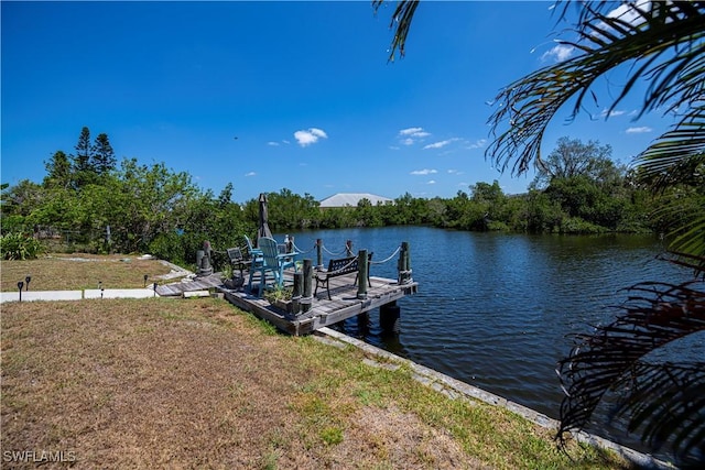 4238 Gardner Dr, Port Charlotte, FL 33952 - dock area featuring a lawn and a water view