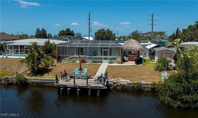 4238 Gardner Dr, Port Charlotte, FL 33952 - rear view of house featuring a lawn, a patio, a water view, and an outdoor pool