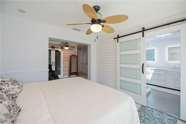 4238 Gardner Dr, Port Charlotte, FL 33952 - bedroom with visible vents, a barn door, a sink, and ceiling fan