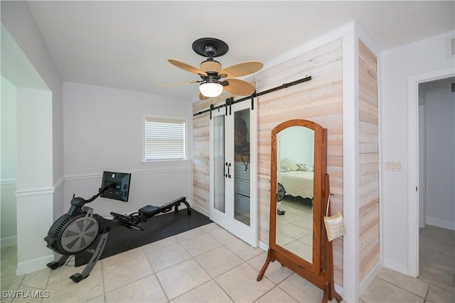 4238 Gardner Dr, Port Charlotte, FL 33952 - workout area with visible vents, a barn door, ceiling fan, and tile patterned floors