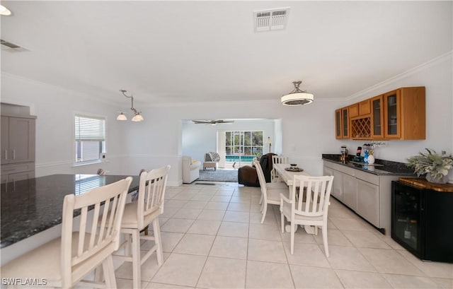 4238 Gardner Dr, Port Charlotte, FL 33952 - interior space with crown molding, a wealth of natural light, brown cabinets, and visible vents