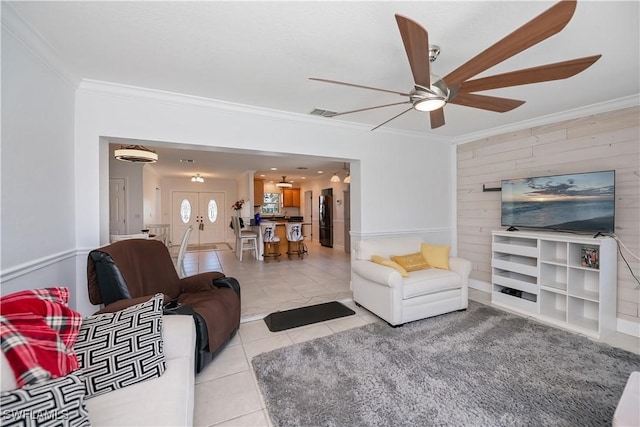 4238 Gardner Dr, Port Charlotte, FL 33952 - living room with ornamental molding, a ceiling fan, tile patterned floors, and wood walls