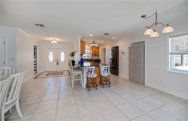 4238 Gardner Dr, Port Charlotte, FL 33952 - kitchen featuring freestanding refrigerator, dark countertops, visible vents, and a healthy amount of sunlight