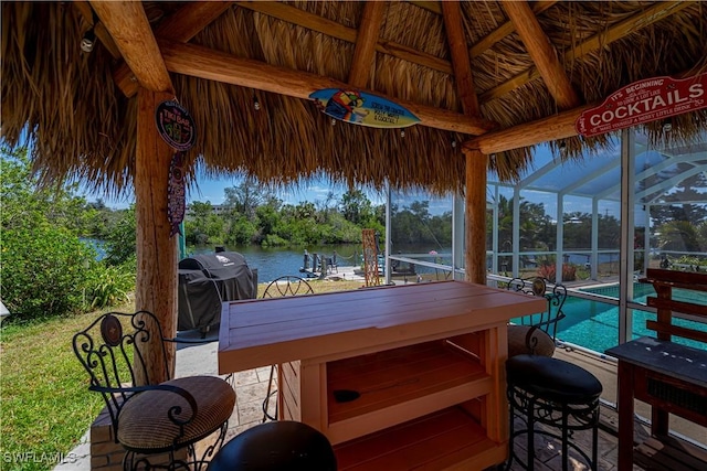 4238 Gardner Dr, Port Charlotte, FL 33952 - exterior space with an outdoor bar, an outdoor pool, a gazebo, a water view, and glass enclosure