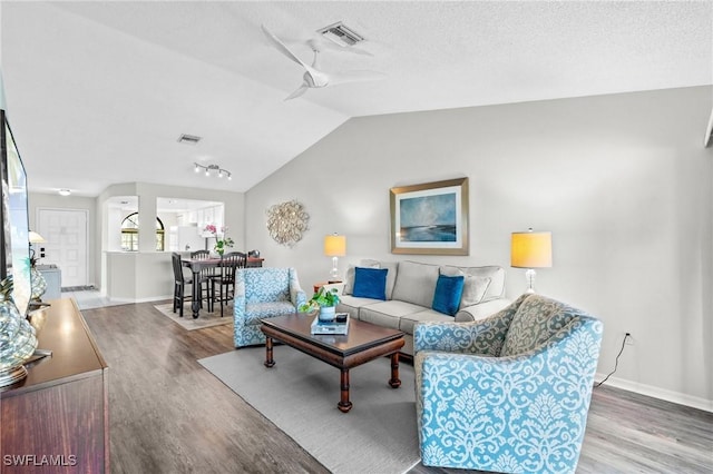 701 Augusta Blvd Unit 701-7, Naples, FL 34113 - living room with wood finished floors, vaulted ceiling, ceiling fan, baseboards, and rail lighting