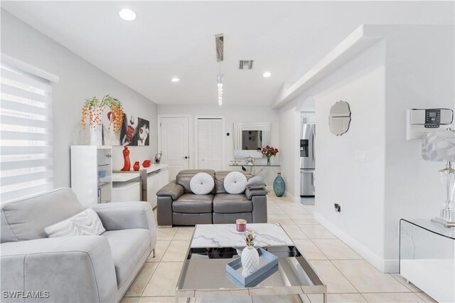 living area featuring baseboards, visible vents, recessed lighting, and light tile patterned floors