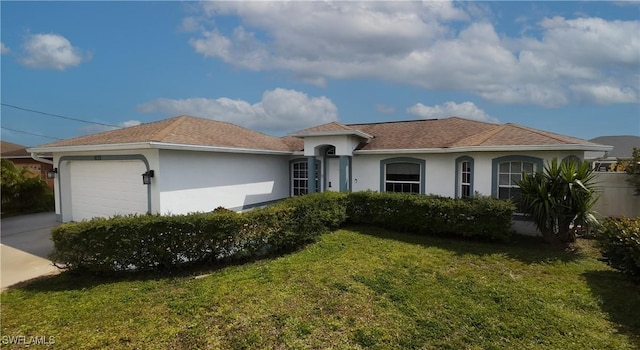 view of front of home with a front yard, an attached garage, stucco siding, and concrete driveway