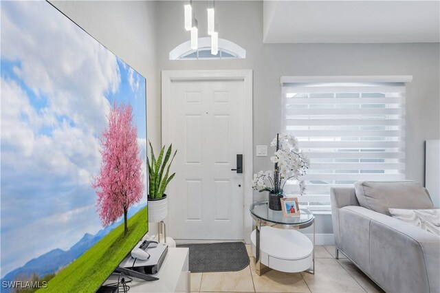 entrance foyer with light tile patterned floors and baseboards