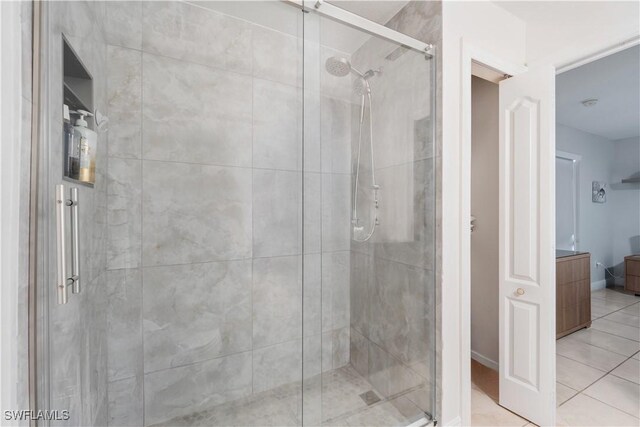 full bath featuring tile patterned floors and a stall shower