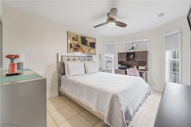 bedroom with baseboards, ceiling fan, and light tile patterned floors