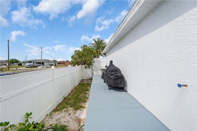 exterior space with stucco siding and fence