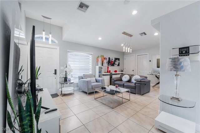 living area featuring visible vents, recessed lighting, and light tile patterned floors