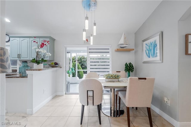 dining area featuring light tile patterned flooring and baseboards