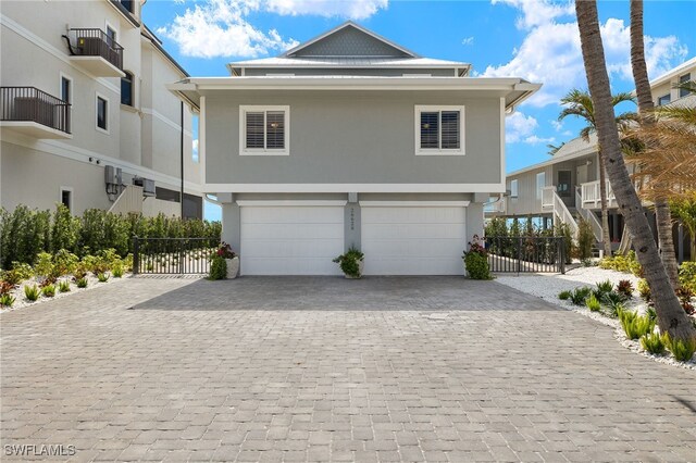 26628 Hickory Blvd, Bonita Springs, FL 34134 - view of front of property featuring a garage, decorative driveway, and stucco siding