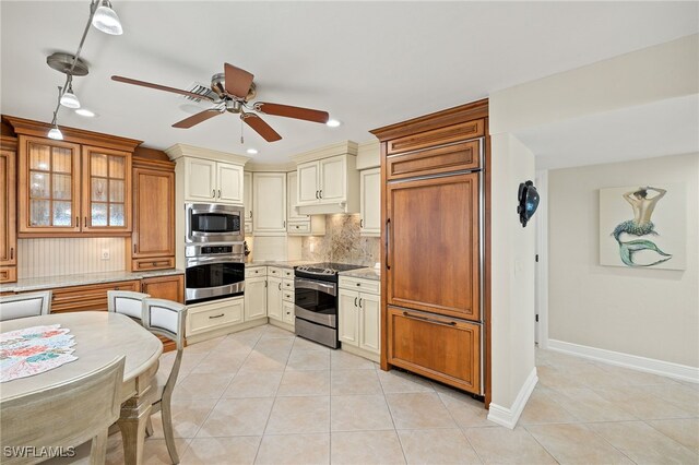 26628 Hickory Blvd, Bonita Springs, FL 34134 - kitchen with built in appliances, tasteful backsplash, light tile patterned floors, a ceiling fan, and light stone countertops