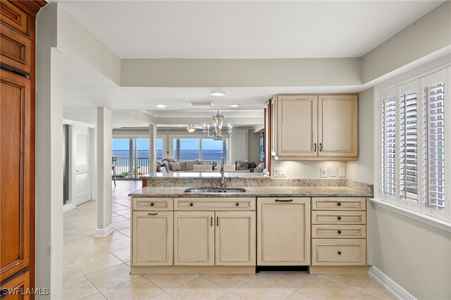 26628 Hickory Blvd, Bonita Springs, FL 34134 - kitchen with cream cabinets, open floor plan, light tile patterned floors, and a peninsula