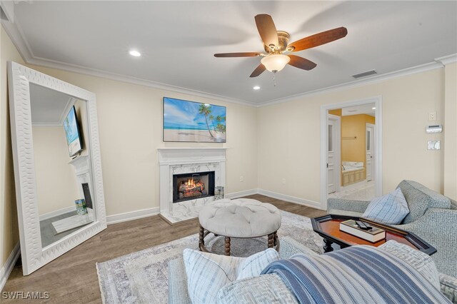 26628 Hickory Blvd, Bonita Springs, FL 34134 - living area with a premium fireplace, wood finished floors, a ceiling fan, ornamental molding, and recessed lighting